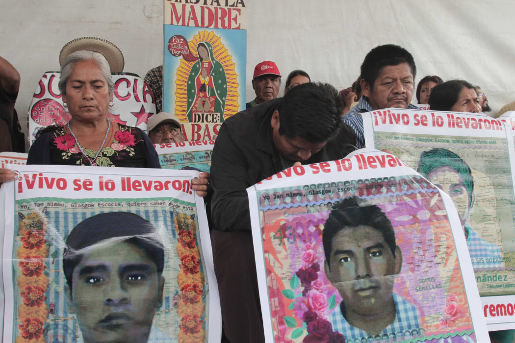 Relatives of the 43 missing students from Ayotzinapa protest at Zocalo Square in Mexico City.