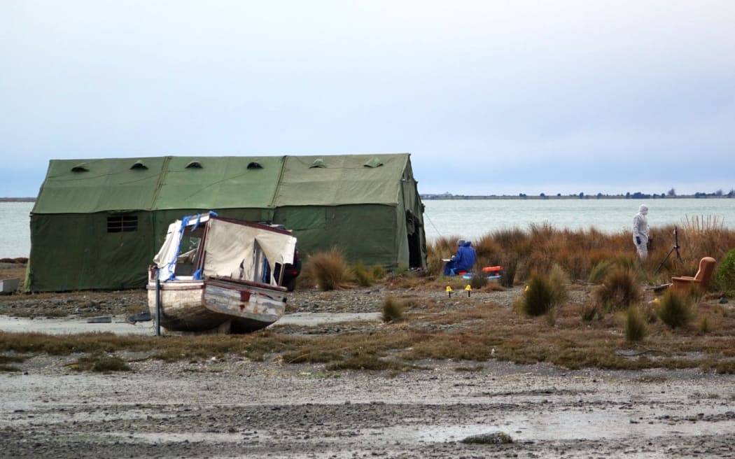 Nelson police at the scene where the body of a man was found on board a boat.