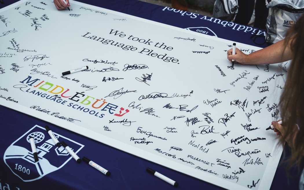 Students signing the Language Pledge