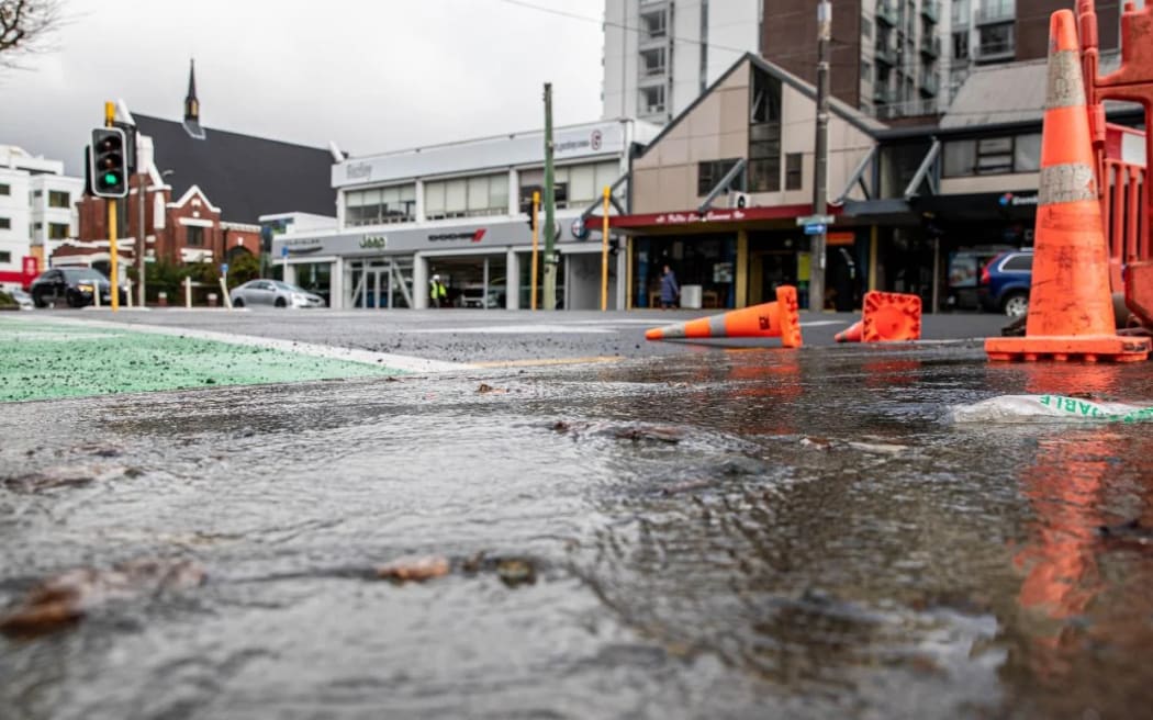 Water spills out onto the footpath, before heading down onto the road and into the turning lane.