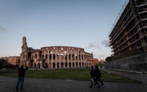People walk in Rome, Italy, on March 13, 2021 during the Covid-19 pandemic.