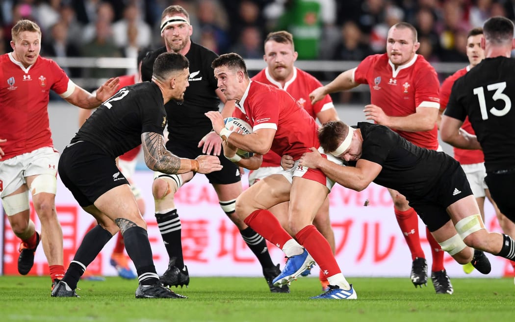 New Zealand v Wales - Rugby World Cup Bronze Final - Owen Watkin of Wales is tackled by Sonny Bill Williams and Sam Cane.