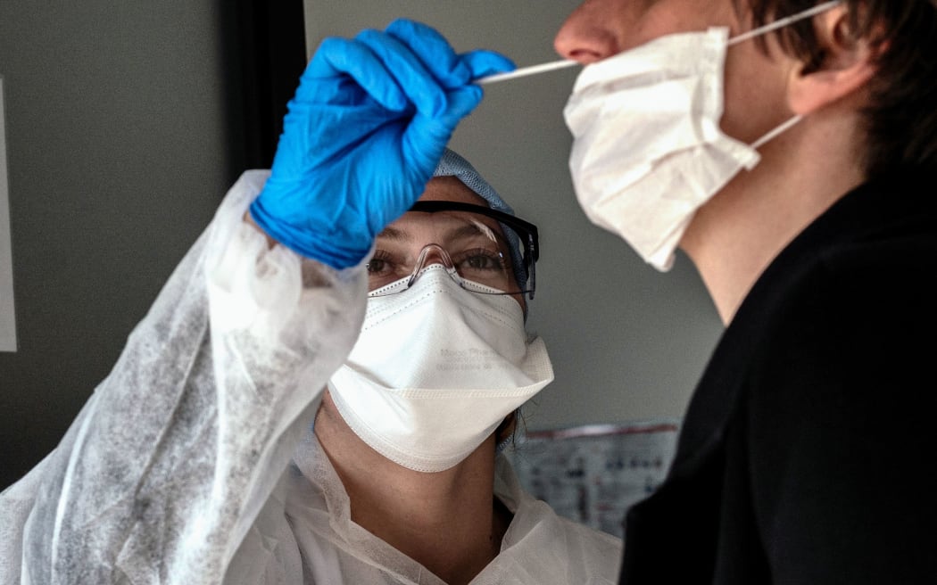 A person has a sample collected to be tested for COVID-19 on March 23, 2020, at the CBM69 laboratory, part of Eurofins clinical diagnostics group, in Villeurbanne, central-eastern France,