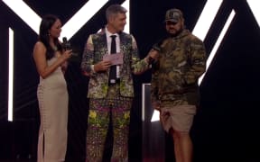 Hori Shaw accepts the award for Breakthrough Artist of the year in his beige crocs.