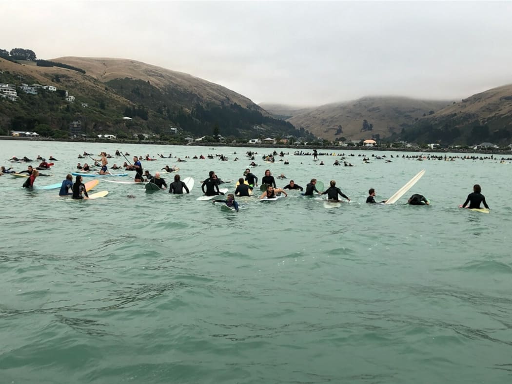 Hundreds of Christchurch surfers have paid tribute to the victims of last week's terror attacks with a paddle-out at Sumner Beach.