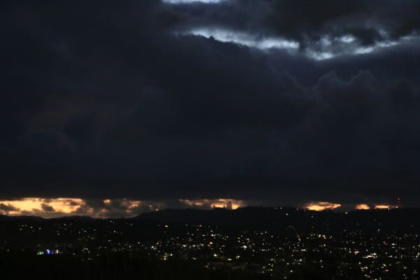 Dark clouds cover the view of sunset from Mount Roskill's summit on 18 February, 2026.