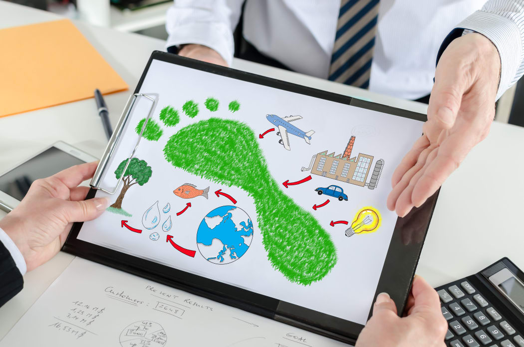 Carbon footprint concept shown by a businessman