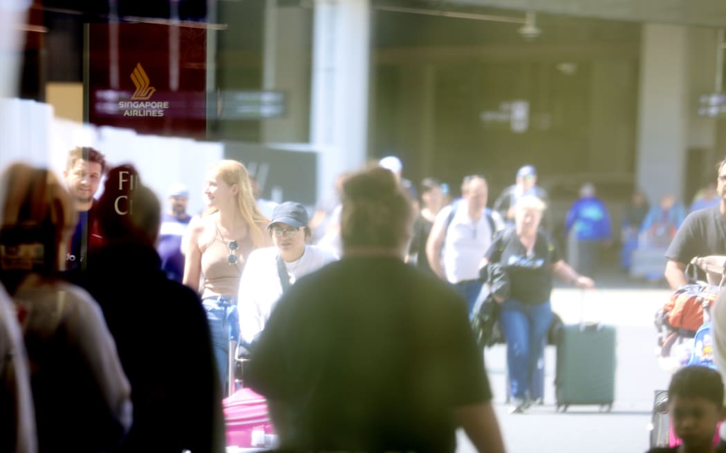 Passengers outside the departures area at Auckland International Airport.