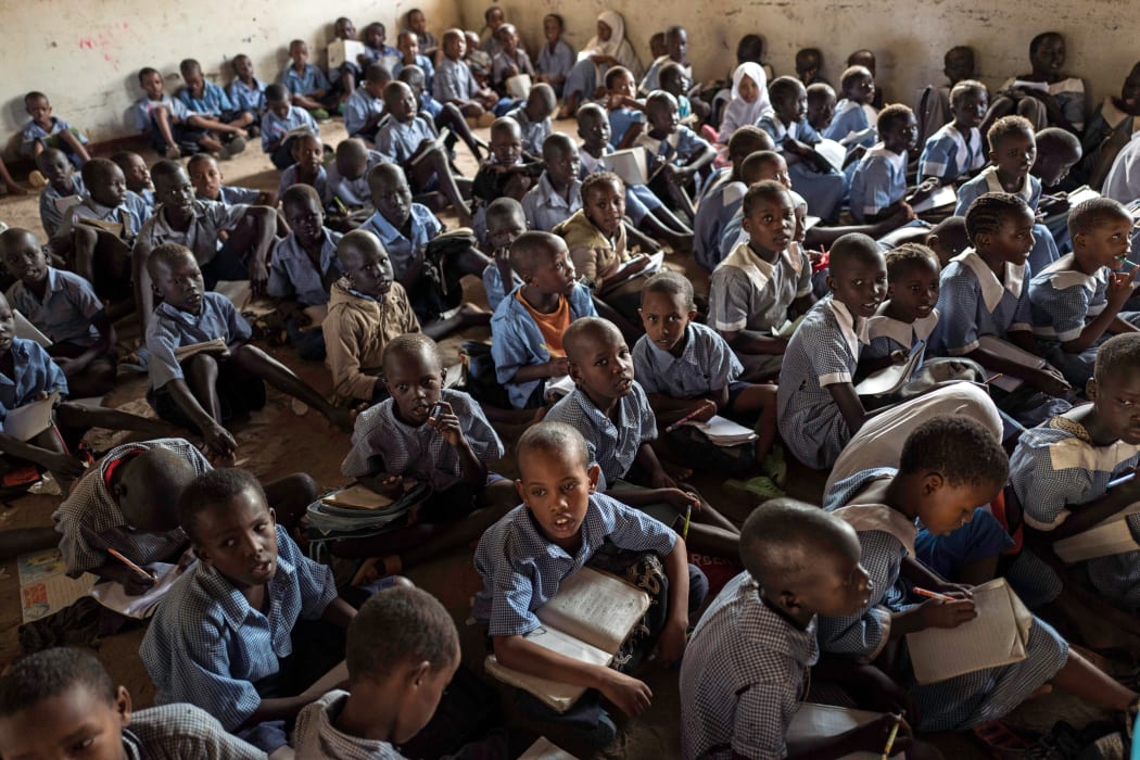 Children sitting on the ground at the primary school class at the refugee camp 1 in Kakuma, Kenya.