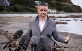 Climate Change Minister James Shaw speaks to media at Owhio Bay, which has been slammed by repeated storms, after revealing the National Adaptation Plan