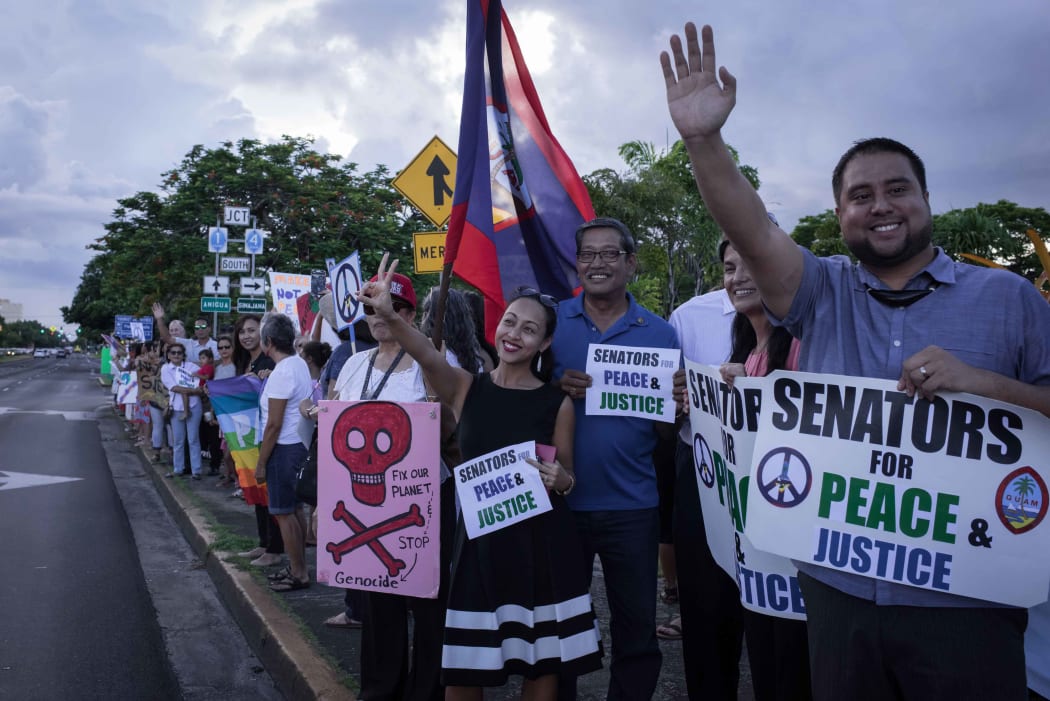 Members of community groups calling for the "de-colonization and de-militarization of Guam" attend a rally for peace in Guam.