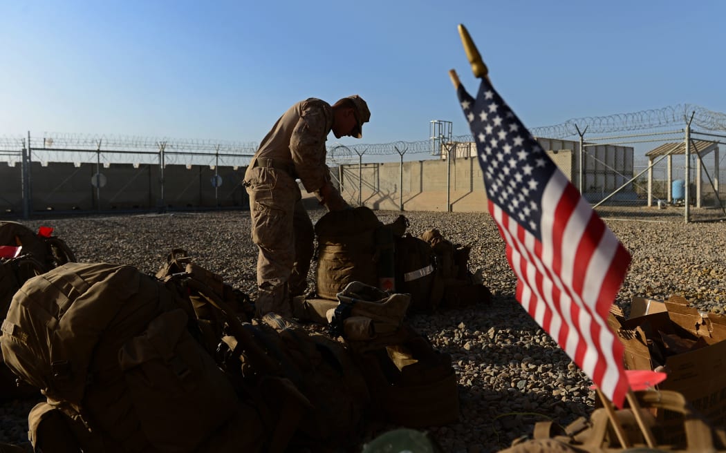 The US force in Afghanistan is be cut to 9,800 by the end of 2014.