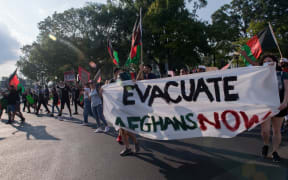 Demonstrators from the "Save Afghan Lives" protest chant as they march towards the U.S. Capitol shutting down Constitution Ave on August 28, 2021 in Washington, DC.