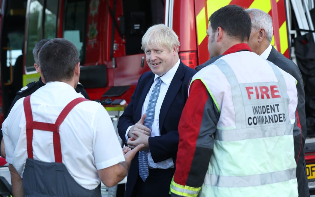 Prime Minister Boris Johnson meets emergency crews at Whaley Bridge Football Club in Derbyshire,