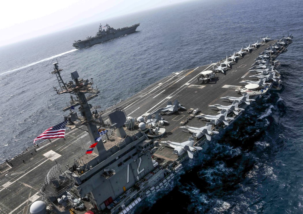 Aircraft carrier USS Abraham Lincoln  and the Amphibious Assault Ship USS Kearsarge (LHD 3) sail in the Arabian Sea in May.
