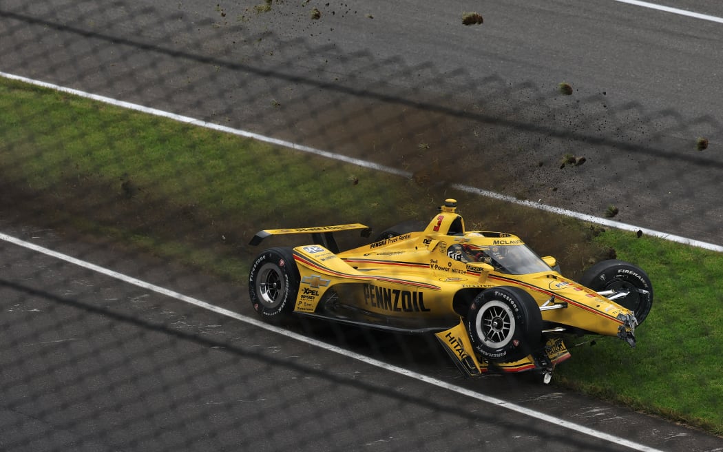 Scott McLaughlin's Team Penske car lies wrecked on the side of the Indianapolis 500 track after he crashed before the race started. 26 May 2025.