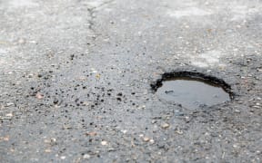 Broken asphalt close up. pothole generic