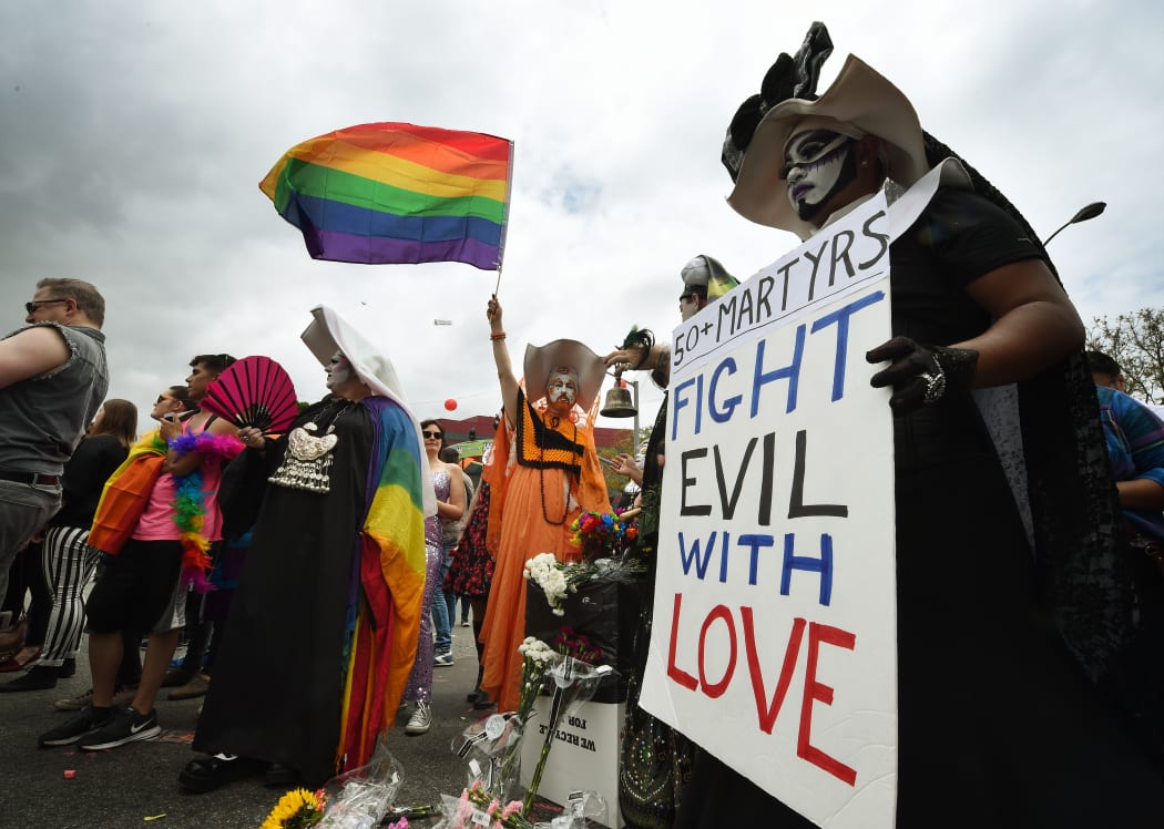 Participants show their support for victims of the Orlando shooting during the 2016 Gay Pride Parade on June 12, 20116 in Los Angeles, California. Security for the tightened in the aftermath of the deadly shootings June 12 at the Pulse, a packed gay nightclub in Orlando, Florida.