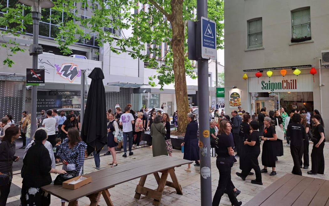 Dozens of people wait it out on High Street as police respond to a nearby incident.
