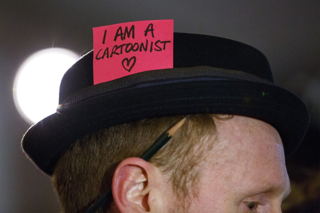 Former resident of Wellington, New Zealand and cartoonist Rufus Daygloattends a silent vigil in Trafalgar Square, London.
