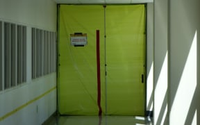 Asbestos warning sign on door