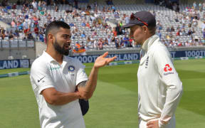 India captain Virat Kohli, talks to England captain, Joe Root (right).