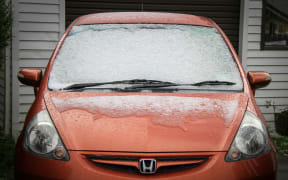Snow slowly melts off a car in Karori.