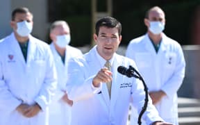 White House physician Sean Conley answers questions surrounded by other doctors, during an update on the condition of US President Donald Trump, on October 4, 2020, at Walter Reed Medical Center in Bethesda, Maryland.