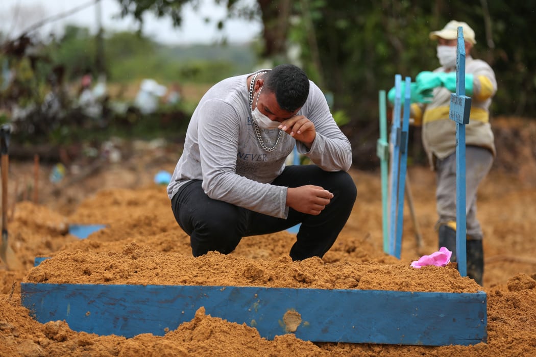 Vito Soares mourns his grandmother, Enedina Soares ,71, a victim of Covid-19 coronavirus at the Nossa Senhora cemetery in Manaus, Brazil, on May 6, 2020.
