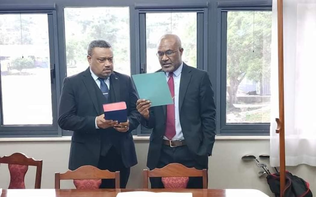 William Timaka, left, with Attorney-General Kiel Loughman taking oath on 14 July 2023.