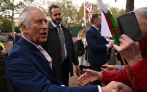 Britain's King Charles III speaks to well-wishers on The Mall near to Buckingham Palace in central London, on 5 May, 2023, ahead of the coronation weekend.