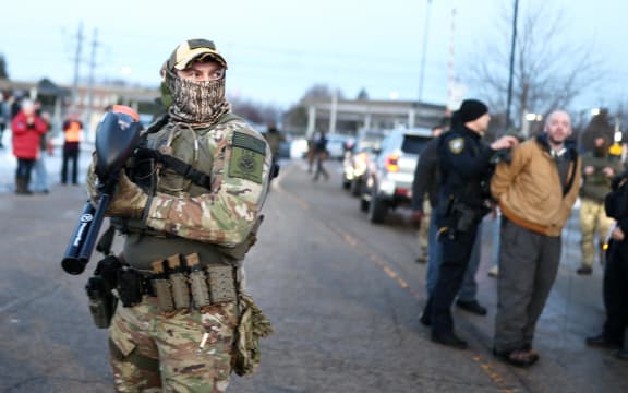 Federal agents detain a protester near the Bishop Henry Whipple Federal Building in Minneapolis, Minnesota, on 9 January 9, 2026. A US Immigration and Customs Enforcement (ICE) agent shot and killed an American woman on the streets of Minneapolis January 7, leading to huge protests and outrage from local leaders who rejected White House claims she was a domestic terrorist. The woman, identified in local media as 37-year-old Renee Nicole Good, was hit at point blank range as she apparently tried to drive away from agents who were crowding around her car, which they said was blocking their way. (Photo by CHARLY TRIBALLEAU / AFP)