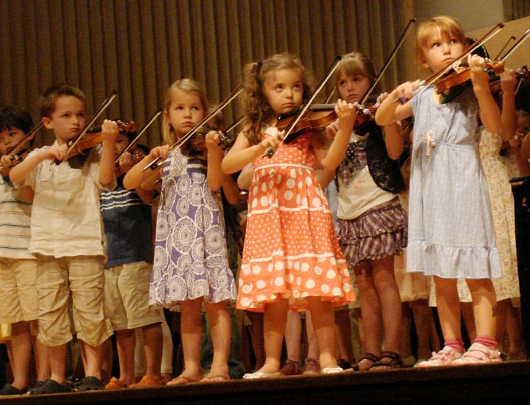 Children playing violin in a group recital, Suzuki Institute, Ithaca