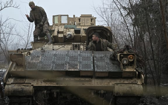 Ukrainian servicemen of the 47th Mechanized Brigade prepare for combat a Bradley fighting vehicle, not far away from Avdiivka, Donetsk region on February 11, 2024, amid the Russian invasion of Ukraine. (Photo by Genya SAVILOV / AFP)