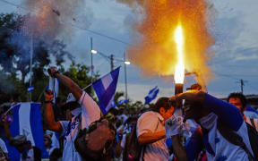 Demonstrators protest during a march from Catarina City to Niquinohomo City to demand justice for the deaths in recent protests in Niquinohomo City, some 40 km from Managua on May 5, 2018