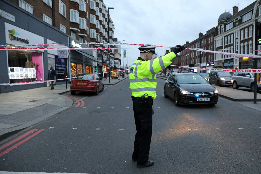 A police officer at a cordon on Streatham High Road, south London, after a man is shot dead by police following reports of a stabbing.