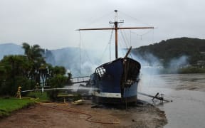 Firefighters dampen down the remains of the Tui on Wednesday morning.