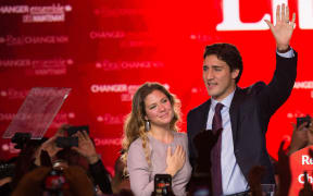 Canadian Liberal Party leader Justin Trudeau and his wife Sophie wave on stage in Montreal on 20 October 2015 after winning the general election.