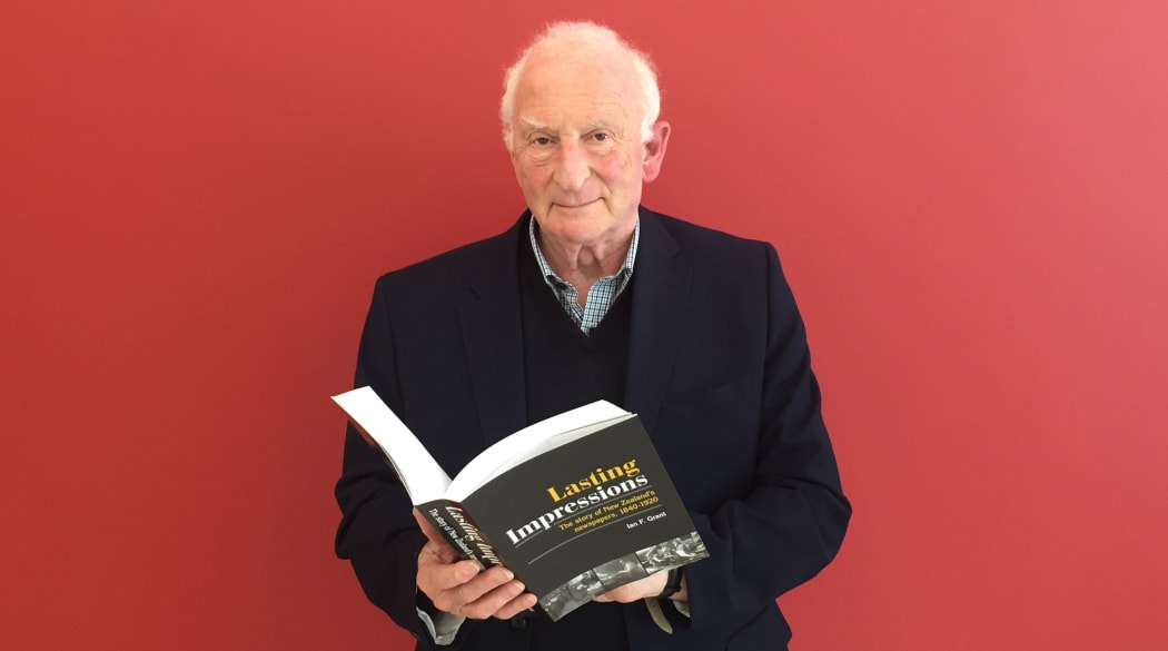 Ian F Grant with his new book covering 80 years of new Zealand newspaper history.