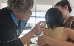Donna Moon vaccinating a child.