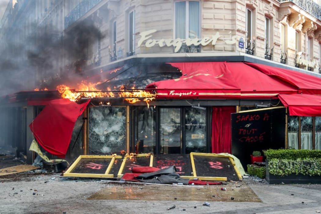 A restaurant on fire during clashes between riot police and 'gilets jaunes' on the Champs-Elysees, Paris on 16 March.