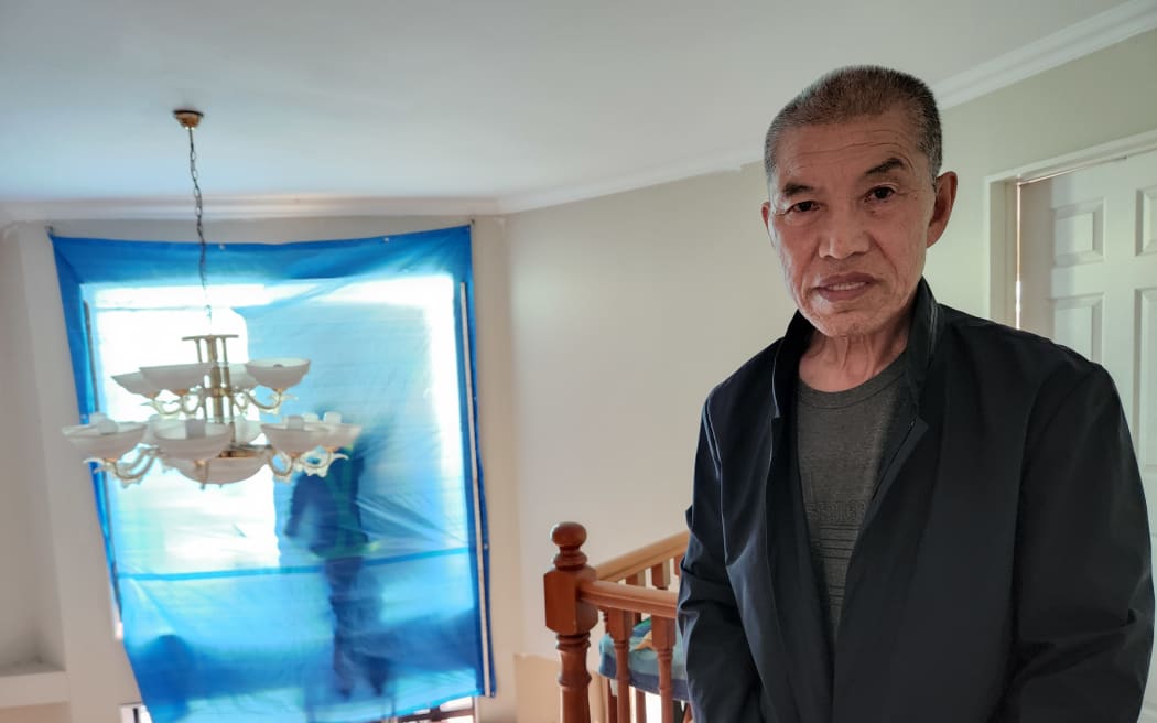 Pei De Hou lives on Erne Crescent in East Tamaki, where many homes were badly damaged.  75 year old Pei De Hou was lying on his bed talking to his friend over the phone, when he heard the sound of the wind and what sounded to him like hail. Initially he thought it was an earthquake. Then he heard a loud bang and decided to check out what was going on, he was shocked to find the damage to the front of his house after branches punctured the window. "The rain was hard-hitting, the rain was like - how it was described [in Chinese literature] - the wind is howling angrily like it could move mountains, the rain was torrential as if it could breach dams and flood rivers." ""I came out of the room and saw that entire top part of the glass window has been broken, and there was glass all over the floor, it was impossible to walk there." A window in the living room and another window on the second floor were also damaged. His home is white stickered and he's happy with the speed of repairs which insurance had arranged.