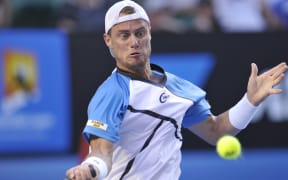 Australian tennis great Lleyton Hewitt plays a shot.
