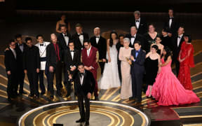 US film producer Jonathan Wang (C) accepts the Oscar for Best Picture for "Everything Everywhere All at Once" onstage during the 95th Annual Academy Awards at the Dolby Theatre in Hollywood, California on March 12, 2023. (Photo by Patrick T. Fallon / AFP)