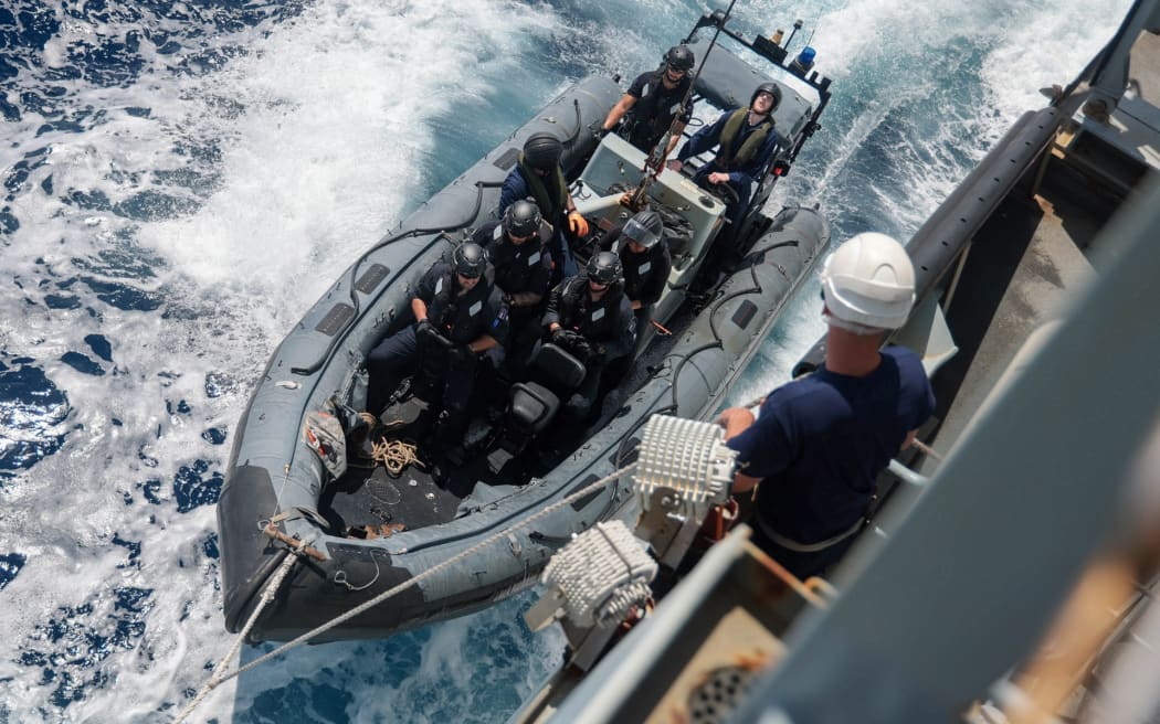 A boarding team comes alongside HMS Tamar