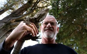 Lindsay Hazley with Henry the tuatara outside the Southland Museum and Art Gallery building