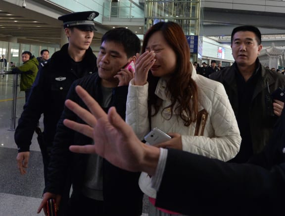 A relative cries at  Beijing Airport after Malaysia Airlines says it is contacting next-of-kin for people on its missing Boeing 777-200 plane.