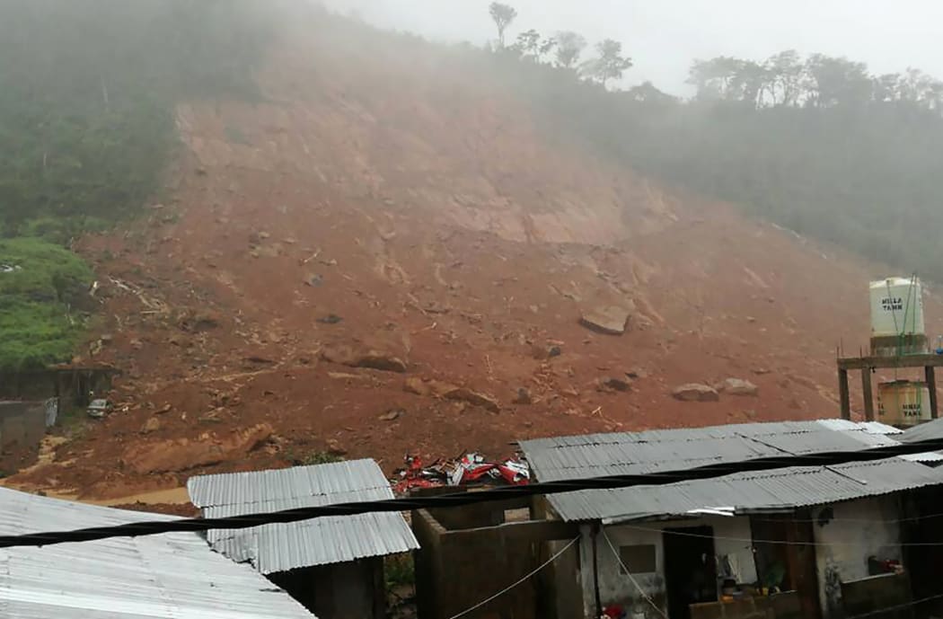 Earth and floodwaters can be seen in the Regent district, on the outskirts of Freetown, on 14 August 2017.