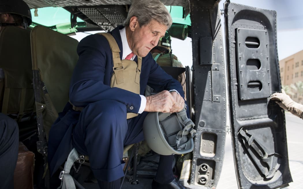 US Secretary of State John Kerry flew into Iraq for talks with its new leaders.
