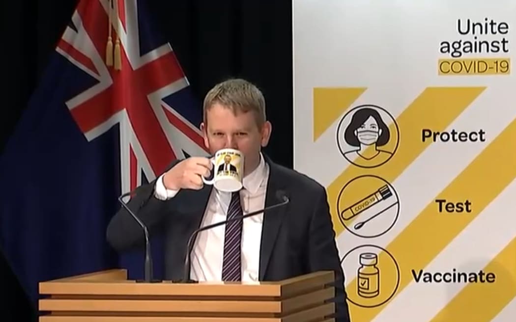 Covid-19 Response Minister Chris Hipkins with the 'spread your legs, not the virus' mug.